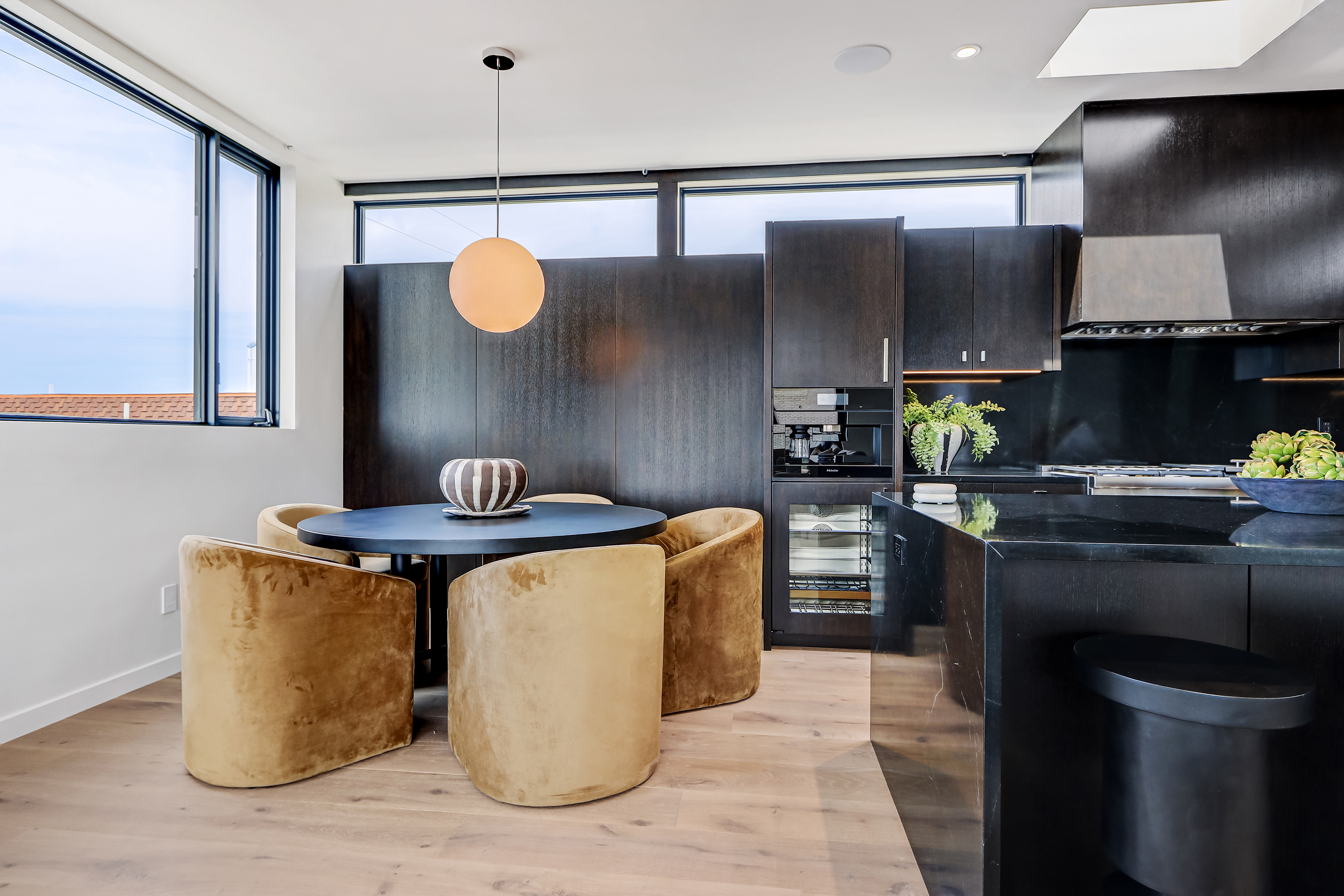 Dining and living area with floor to ceiling glass facing the patio