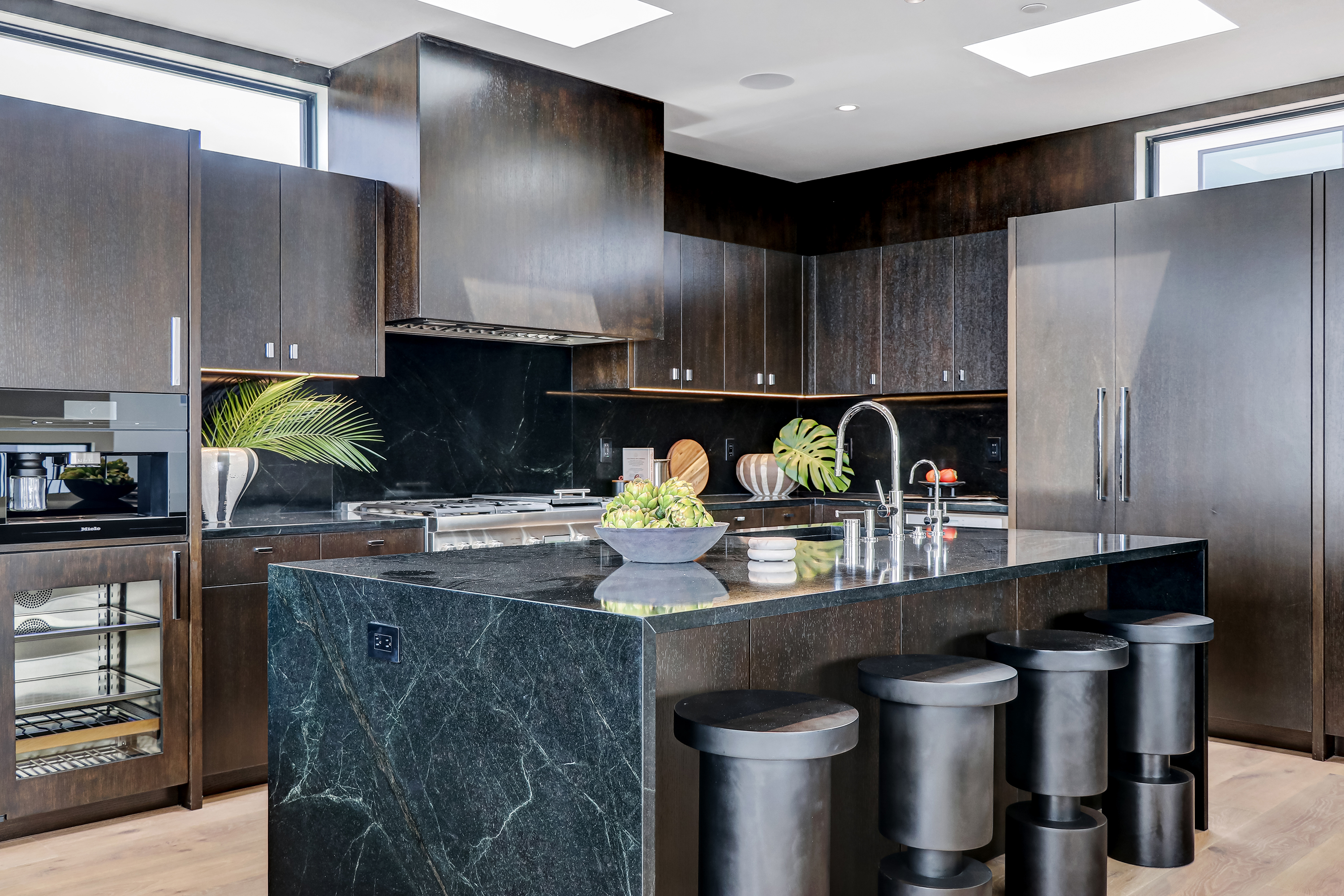 Kitchen wide view with island, dark cabinetry and recessed lighting